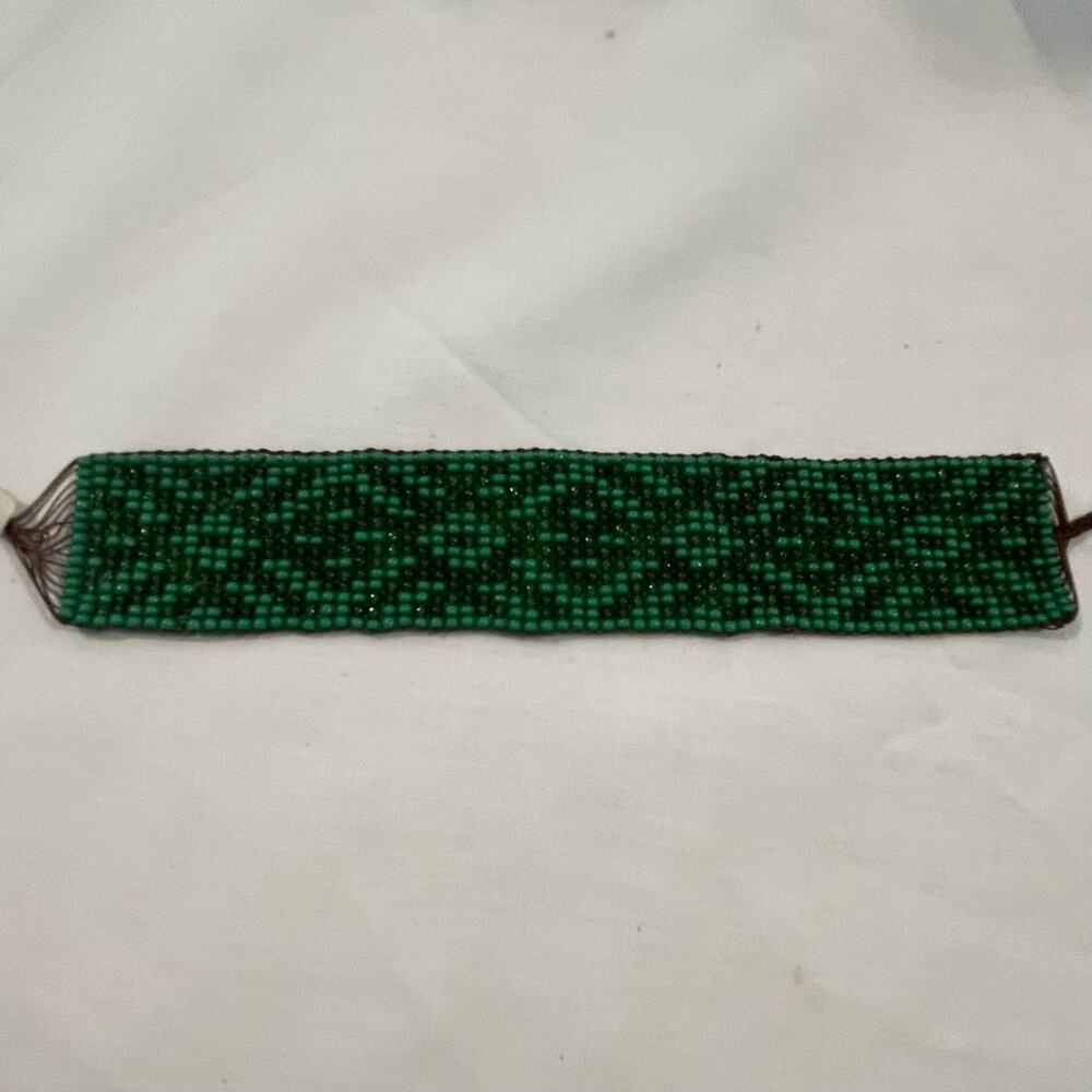 Green beaded bracelet with design